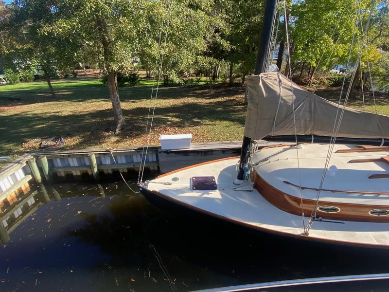 Slide: The Image of 37ft Catboat Yacht docked by a wooded shoreline, Barnegat Bay A-Cat, 2012 model. - 24