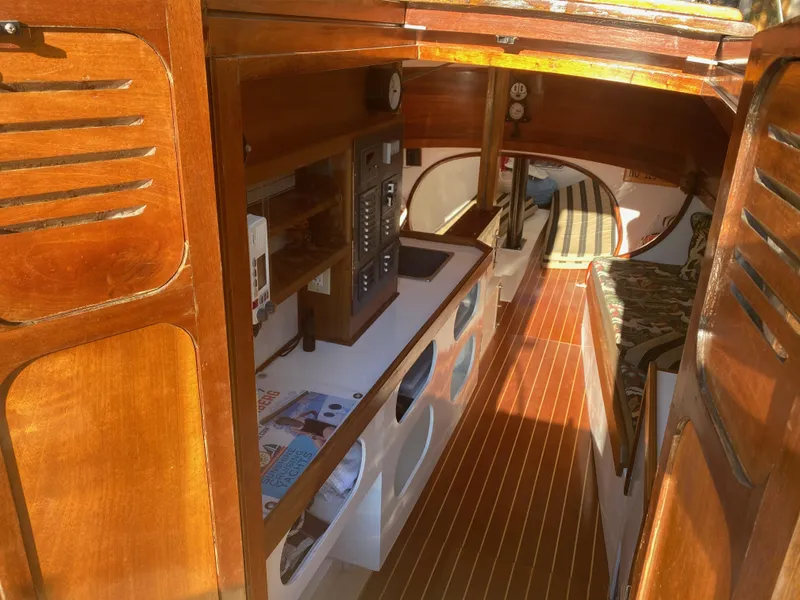 Slide: The Image of Interior of 2012 Custom 37ft Catboat Yacht with wooden finishes and cozy cabin space. - 33