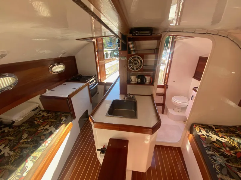 Slide: The Image of Interior of 2012 Custom 37ft Catboat Yacht with kitchen, seating, and bathroom. - 35