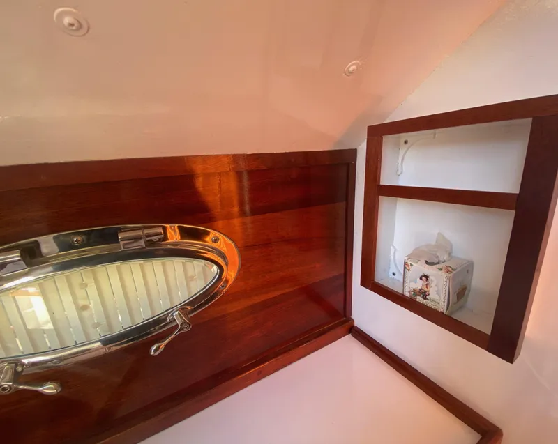 Slide: The Image of Wooden yacht interior with oval porthole and shelf, Custom 37ft Catboat, 2012. - 43
