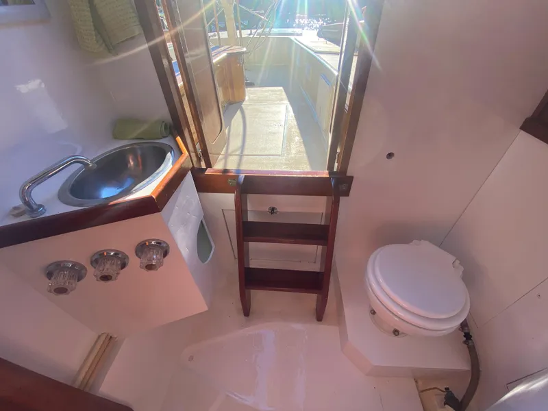 Slide: The Image of 37ft Catboat Yacht bathroom with sink, toilet, and wooden steps, 2012 model. - 45