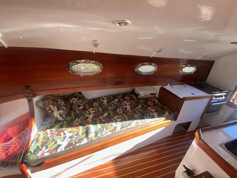 Slide: The Image of Cozy cabin interior of 2012 Custom 37ft Catboat Yacht with wooden finish and floral bedding. - 47