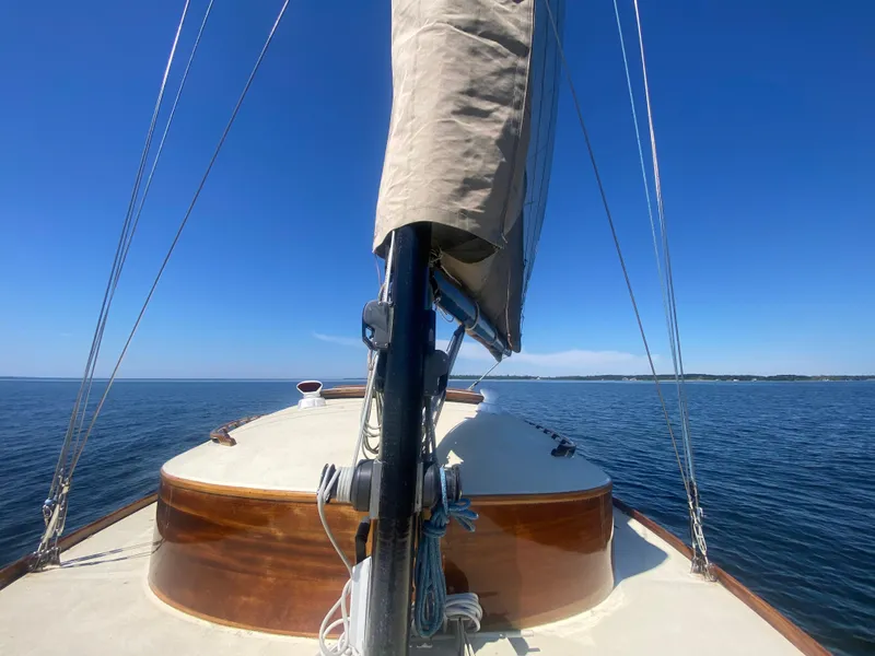 Slide: The Image of 37ft Custom Catboat Yacht sailing on calm waters under clear blue sky. - 9