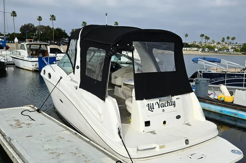 Slide: The Image of 2006 Sea Ray 260 Sundancer docked, featuring black canopy and "Lil Yachty" name on stern. - 14