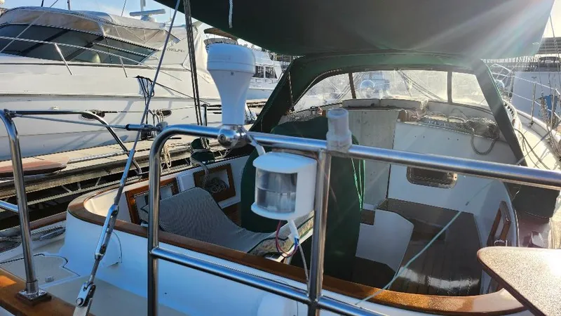 Slide: The Image of 1989 Cabo Rico 34 sailboat cockpit with green canopy, docked at marina. - 16