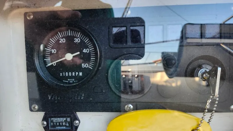 Slide: The Image of Close-up of a 1989 Cabo Rico 34 boat's RPM gauge and control panel. - 19
