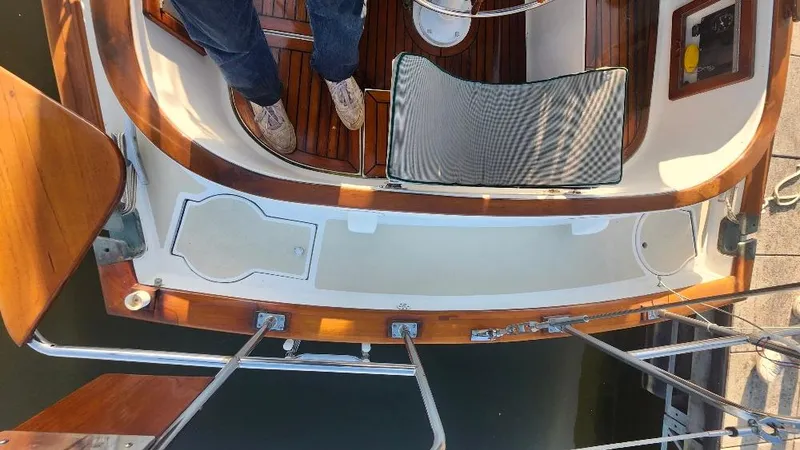 Slide: The Image of Cabo Rico 34 sailboat cockpit, 1989 model, featuring teak wood and nautical design elements. - 26