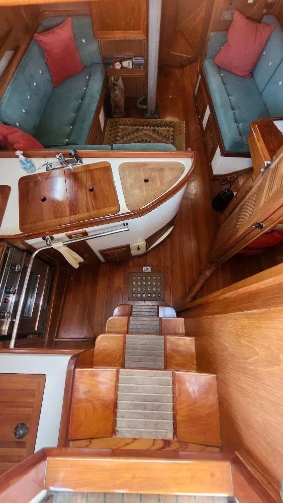 Slide: The Image of Interior of 1989 Cabo Rico 34 sailboat with wooden finishes and cozy seating area. - 37