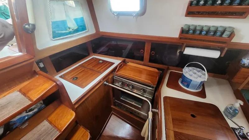 Slide: The Image of Interior of 1989 Cabo Rico 34 sailboat kitchen with wooden cabinetry and stove. - 40