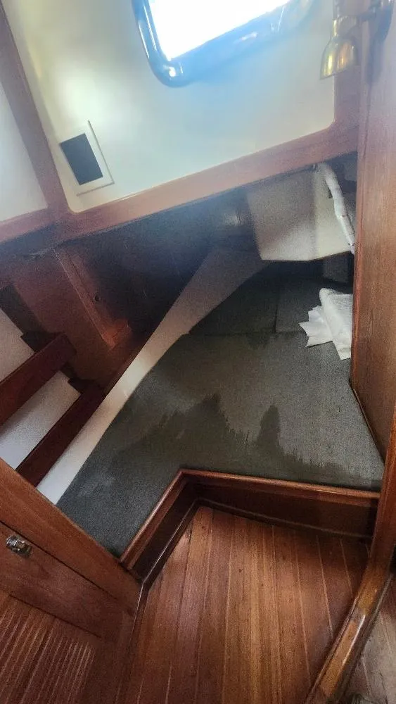 Slide: The Image of Interior cabin of 1989 Cabo Rico 34 sailboat with wooden flooring and window. - 43