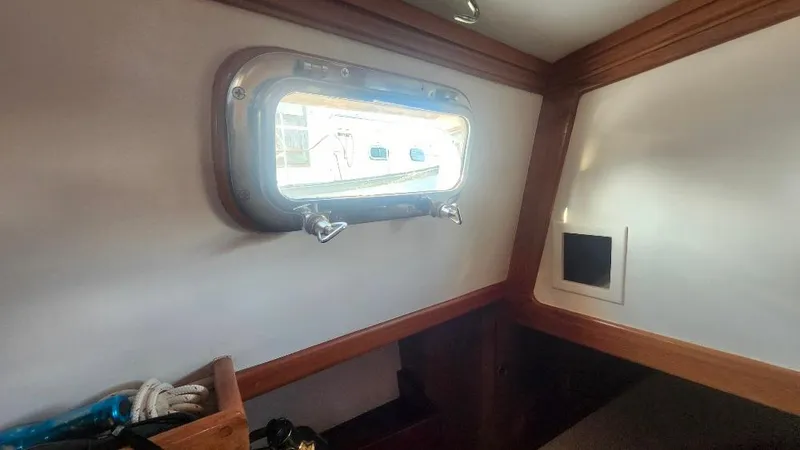 Slide: The Image of Interior of 1989 Cabo Rico 34 sailboat with porthole and wooden trim. - 46