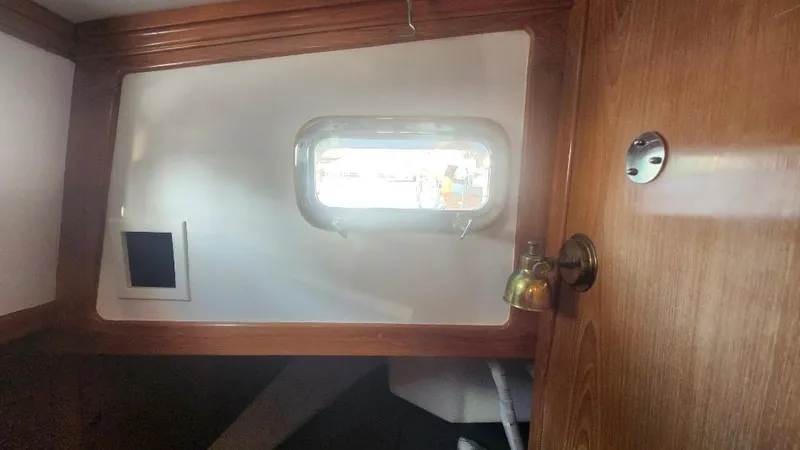 Slide: The Image of Interior of 1989 Cabo Rico 34 sailboat with wooden finish and porthole window. - 47