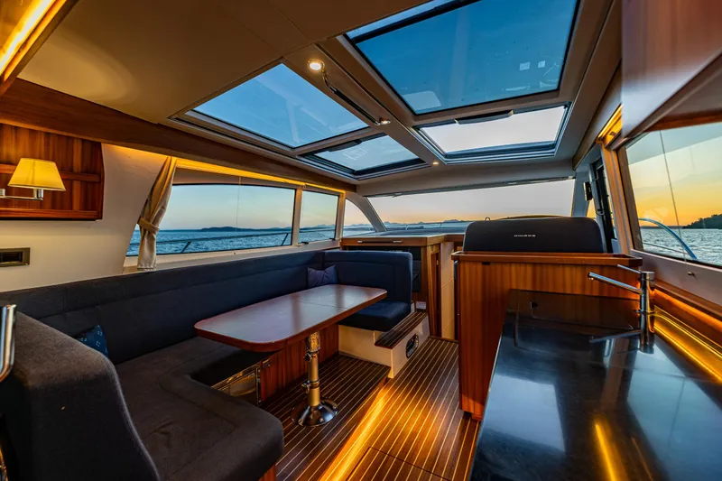 Slide: The Image of Luxurious interior of 2022 Nimbus 405 Coupé yacht with panoramic windows and elegant seating. - 17