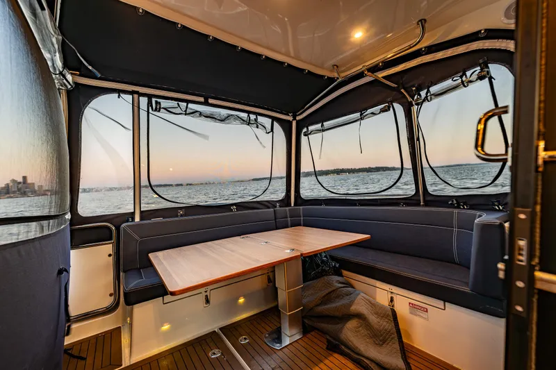 Slide: The Image of Interior of 2022 Nimbus 405 Coupé boat with sunset view through windows. - 18