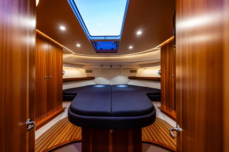 Slide: The Image of Luxurious interior of 2022 Nimbus 405 Coupé yacht with elegant wood finish and skylight. - 25