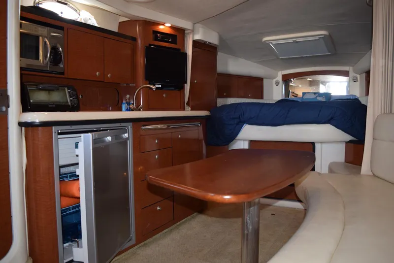 Slide: The Image of Interior of 2005 Sea Ray 340 Sundancer yacht with kitchenette and seating area. - 10