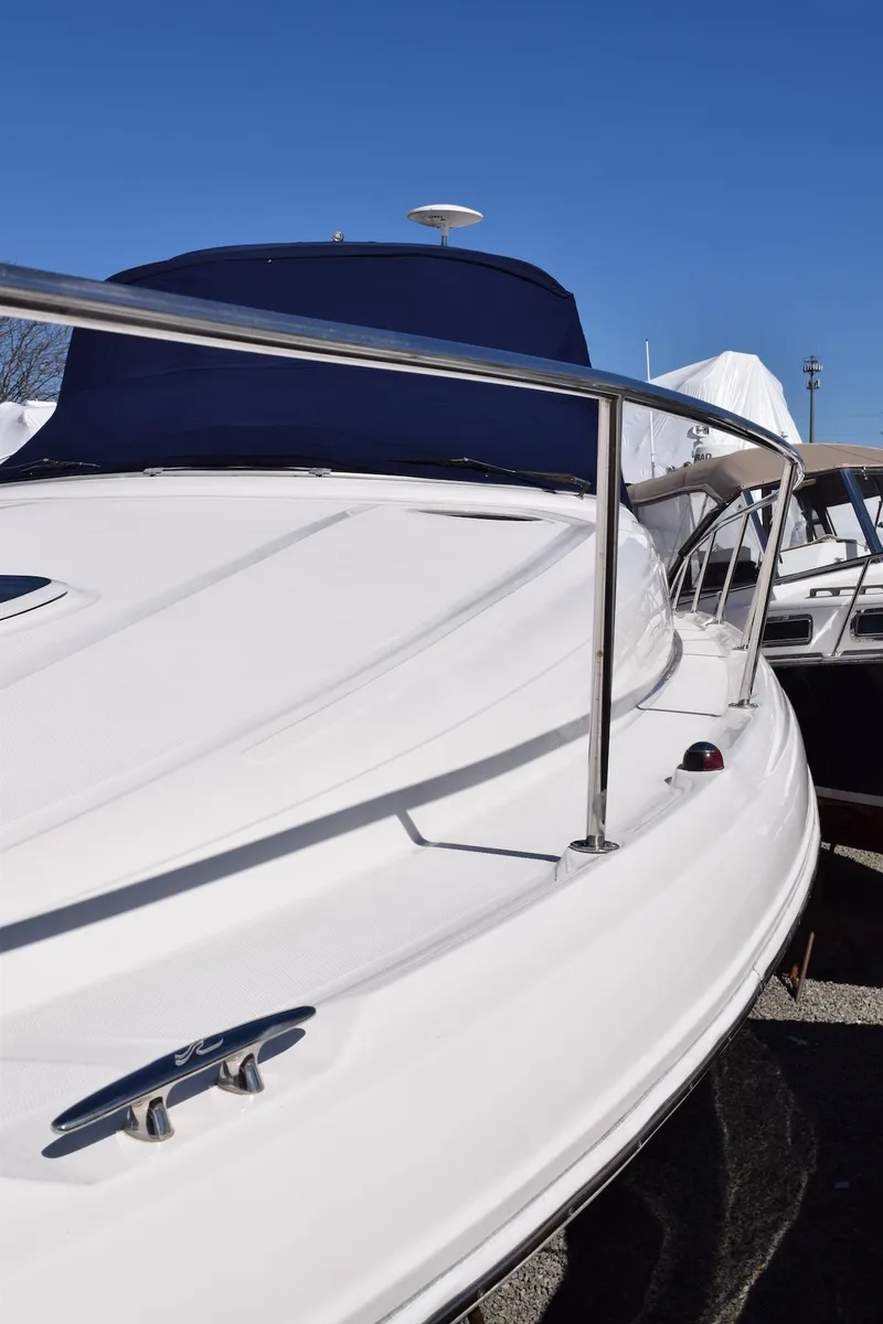Slide: The Image of 2005 Sea Ray 340 Sundancer boat with sleek white deck and stainless steel railing. - 15