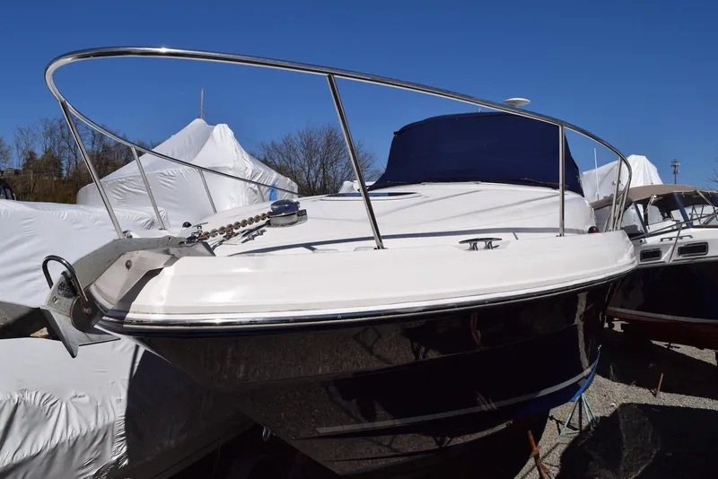 Slide: The Image of 2005 Sea Ray 340 Sundancer boat with sleek design, docked under clear blue sky. - 16