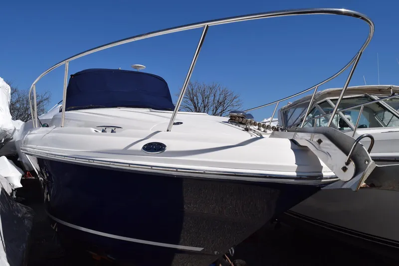 Slide: The Image of 2005 Sea Ray 340 Sundancer boat with blue hull and white deck, docked outdoors. - 20