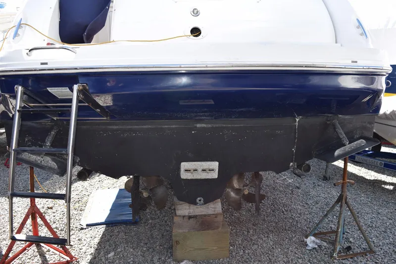 Slide: The Image of 2005 Sea Ray 340 Sundancer boat on stands, showing stern and propellers. - 25