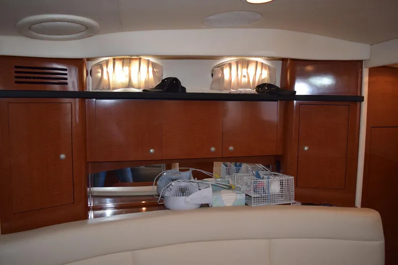 Slide: The Image of Interior of 2005 Sea Ray 340 Sundancer with wooden cabinets and seating area. - 27