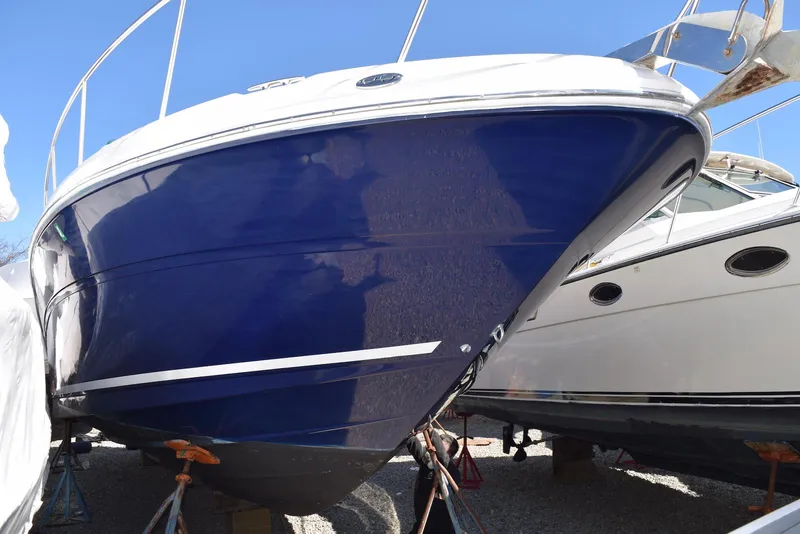 Slide: The Image of 2005 Sea Ray 340 Sundancer boat with blue hull, displayed on stands. - 3