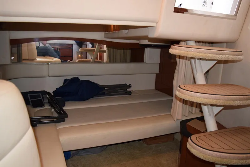 Slide: The Image of Interior cabin of 2005 Sea Ray 340 Sundancer with beige seating and wooden steps. - 31