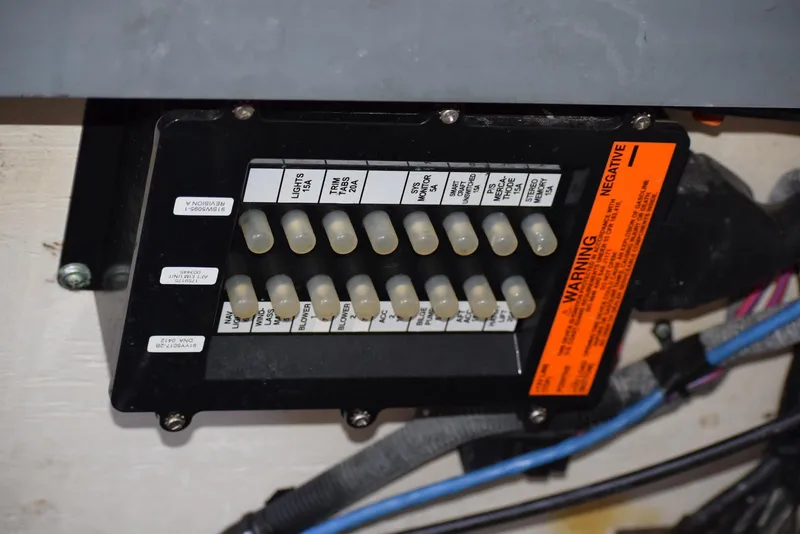 Slide: The Image of Electrical panel on a 2005 Sea Ray 340 Sundancer boat with labeled switches and warning label. - 32