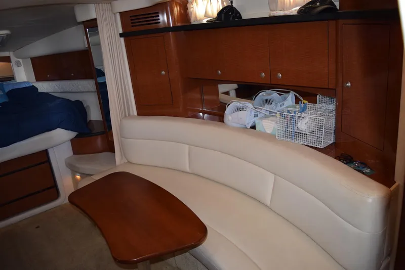 Slide: The Image of Interior of 2005 Sea Ray 340 Sundancer with beige seating and wooden cabinetry. - 34