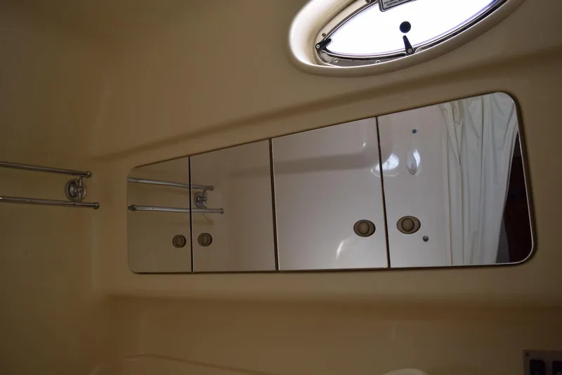 Slide: The Image of Interior of 2005 Sea Ray 340 Sundancer with mirrored cabinets and porthole window. - 36
