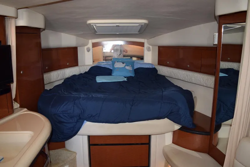 Slide: The Image of 2005 Sea Ray 340 Sundancer cabin with cozy bed and wooden cabinetry. - 37