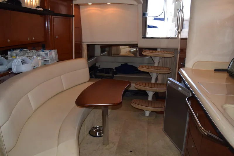 Slide: The Image of Interior of 2005 Sea Ray 340 Sundancer yacht with elegant seating and wooden accents. - 38