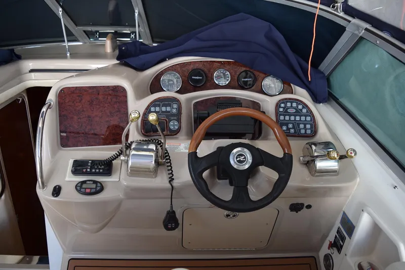 Slide: The Image of 2005 Sea Ray 340 Sundancer helm with wood accents and modern controls. - 39