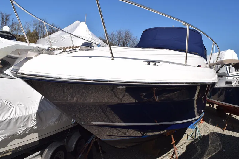 Slide: The Image of 2005 Sea Ray 340 Sundancer boat with blue hull, docked outdoors. - 4
