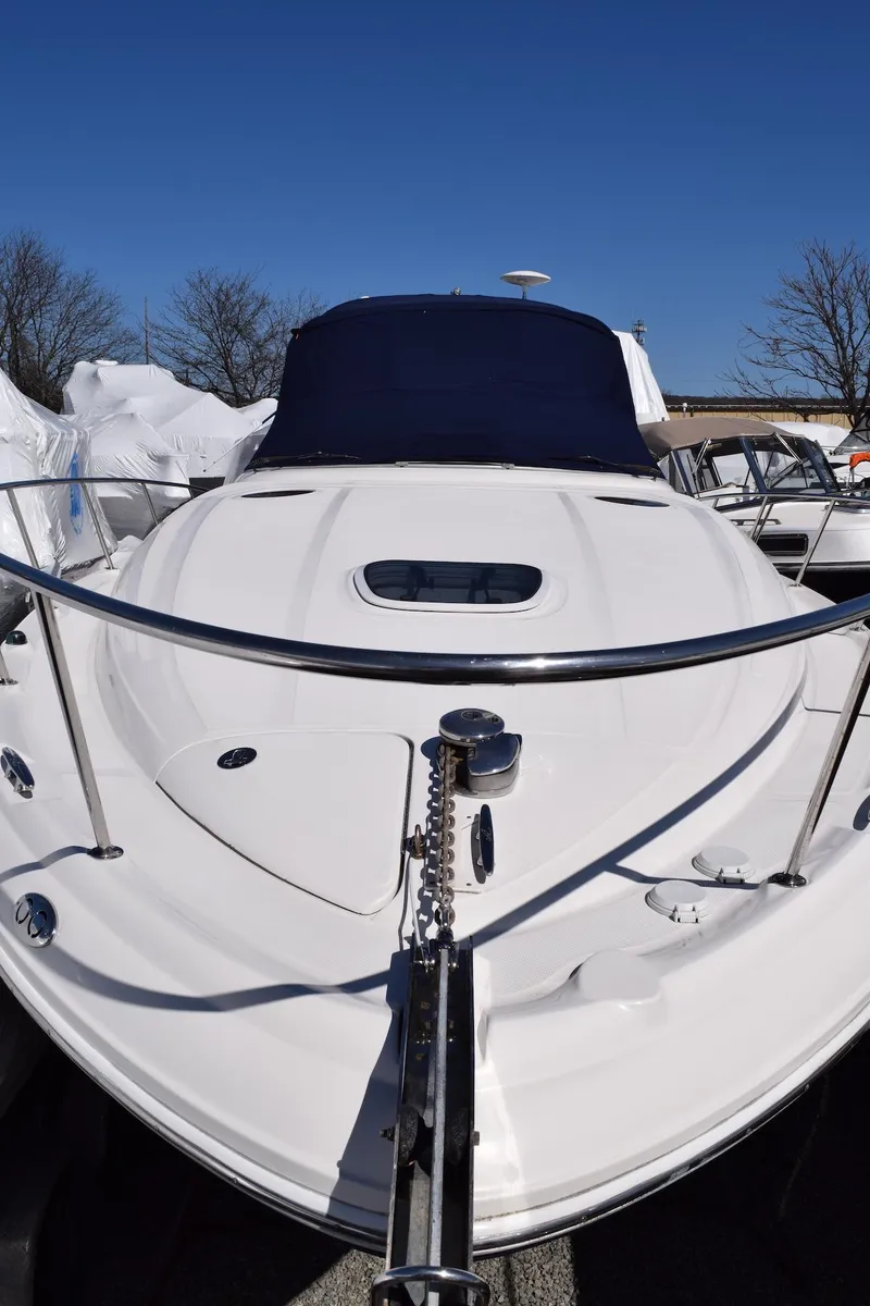 Slide: The Image of 2005 Sea Ray 340 Sundancer boat with sleek white design and blue canopy. - 40