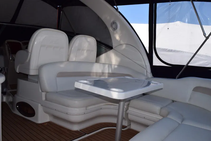 Slide: The Image of 2005 Sea Ray 340 Sundancer interior with white seating and table, featuring sleek design. - 47