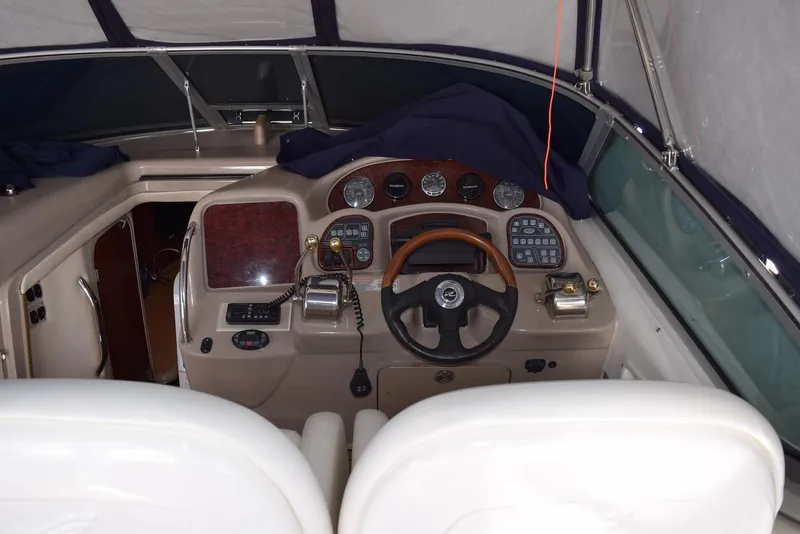 Slide: The Image of 2005 Sea Ray 340 Sundancer helm with steering wheel and control panel. - 49