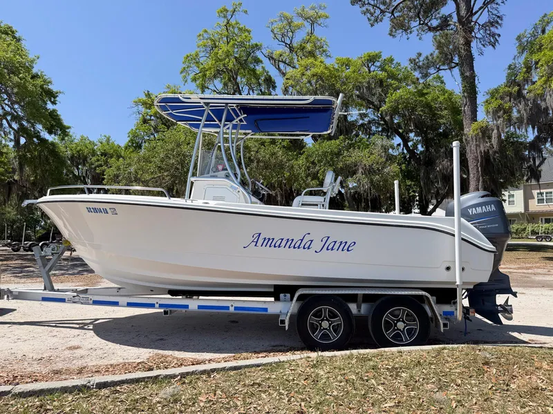 Slide: The Image of 2012 Edgewater 205CC boat named "Amanda Jane" on a trailer, parked outdoors. - 0