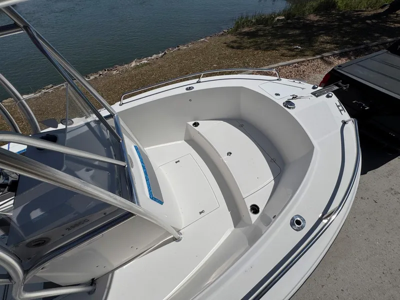 Slide: The Image of 2012 Edgewater 205CC boat with spacious bow seating near a waterfront. - 10