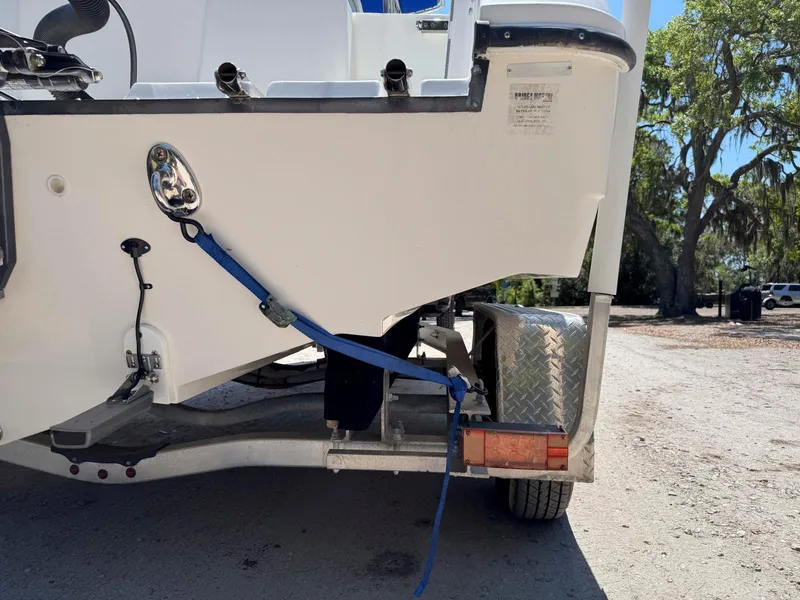 Slide: The Image of Edgewater 205CC boat on trailer, secured with blue strap, outdoors. - 16