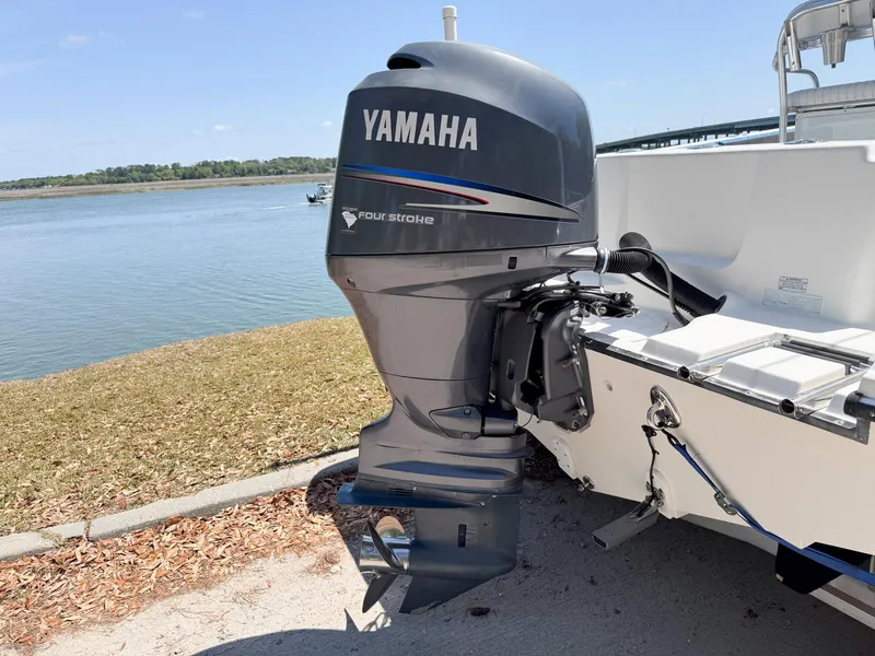 Slide: The Image of Edgewater 205CC 2012 boat with Yamaha four-stroke outboard motor by a lake. - 18