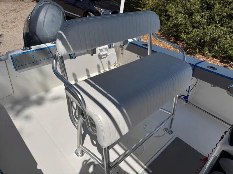 Slide: The Image of 2012 Edgewater 205CC boat interior with white cushioned seating and metal frame. - 4