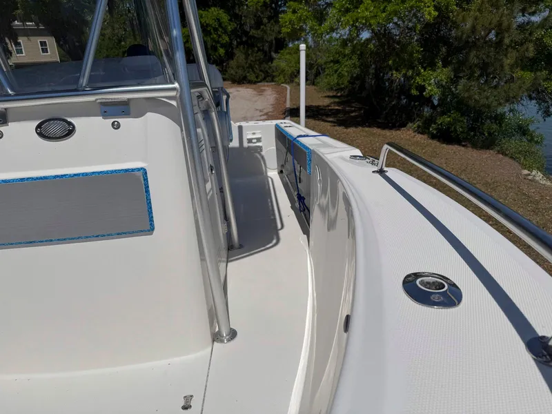 Slide: The Image of 2012 Edgewater 205CC boat interior with sleek white deck and stainless steel railings. - 6