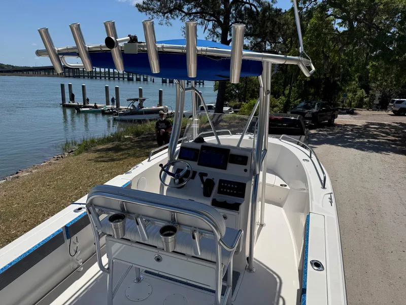 Slide: The Image of 2012 Edgewater 205CC boat docked by a scenic waterfront with clear skies. - 8