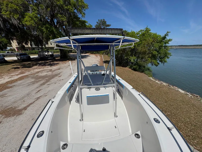 Slide: The Image of Edgewater 205CC 2012 boat docked by a scenic riverside under clear blue skies. - 9