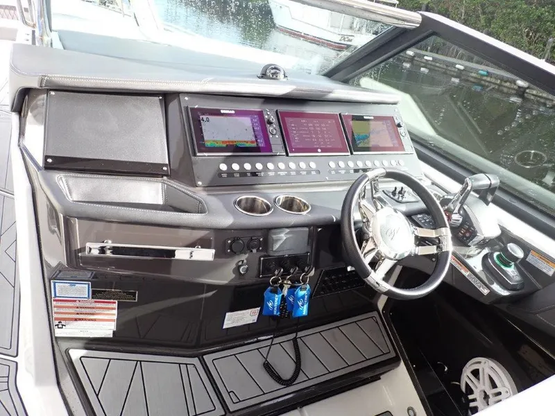 Slide: The Image of 2023 Monterey 385 Super Sport boat dashboard with modern controls and navigation screens. - 11