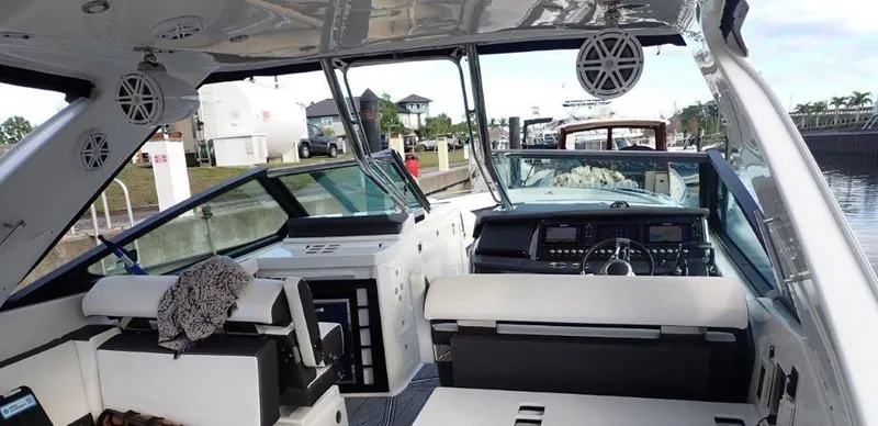 Slide: The Image of 2023 Monterey 385 Super Sport boat interior with modern dashboard and seating. - 13