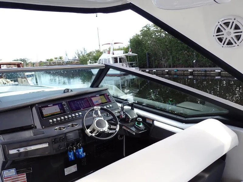 Slide: The Image of 2023 Monterey 385 Super Sport boat interior with modern dashboard and steering wheel. - 14