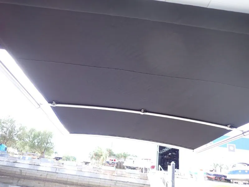 Slide: The Image of 2023 Monterey 385 Super Sport boat with extended black canopy, outdoor setting. - 15