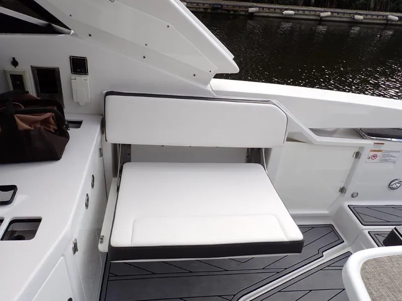 Slide: The Image of 2023 Monterey 385 Super Sport boat interior with white seating by the water. - 16